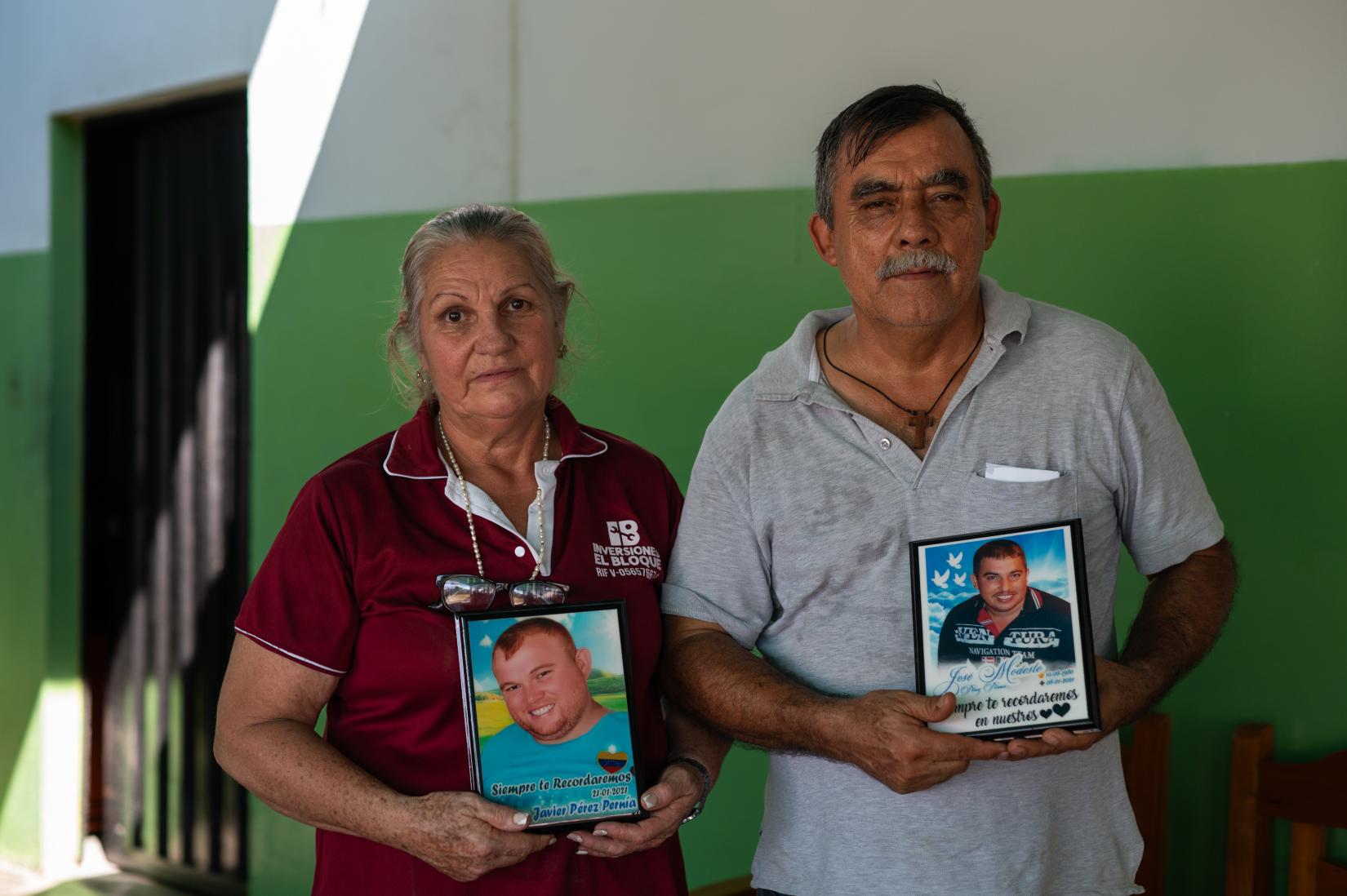 Elvia Del Socorro y su esposo Modesto Pérez muestran las fotos de sus hijos, quienes fallecieron durante la pandemia de la COVID-19.